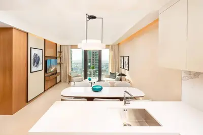 a kitchen with a sink and a table in a room at Prime Retreats @ Address Residence Opera By Emaar in Dubai