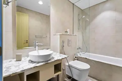 a bathroom with a sink and a toilet and a shower at StoneTree - Furnished 2BR with Luxurious Style in Dubai