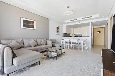 a living room with a couch and a table at StoneTree - Furnished 2BR with Luxurious Style in Dubai