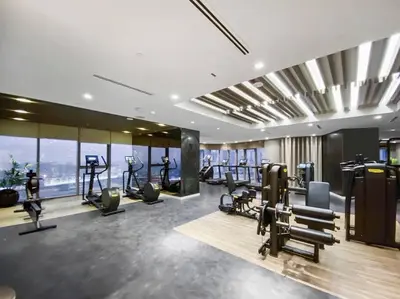 a gym with treadmills and ellipticals in a building at StoneTree - Furnished 2BR with Luxurious Style in Dubai