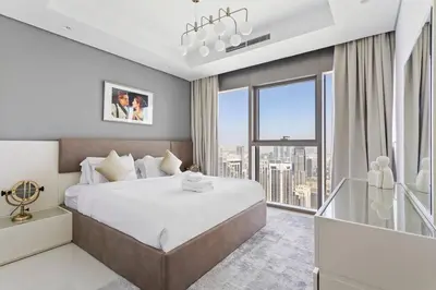 a bedroom with a large bed and a large window at StoneTree - Furnished 2BR with Luxurious Style in Dubai
