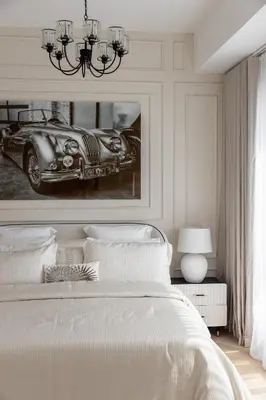a bedroom with a bed and a picture of a car at Beautiful stylish 1 bedroom by the JBR beach ! in Dubai