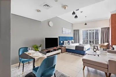 a large living room with a bed and a couch at StoneTree - Stylish Studio near Metro Station in Dubai