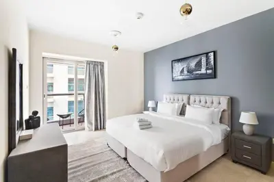 a bedroom with a large white bed and a window at StoneTree - Sea View - High-Floor in Dubai