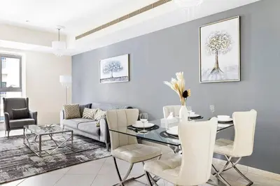 a living room with a table and a couch at StoneTree - Sea View - High-Floor in Dubai