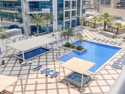 an overhead view of a swimming pool on a building at StoneTree - Furnished 1BR near Marina Walk in Dubai