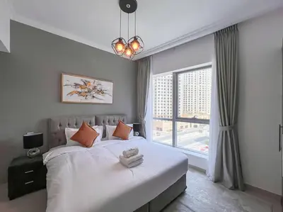 a bedroom with a large bed and a large window at StoneTree - Furnished 1BR near Marina Walk in Dubai