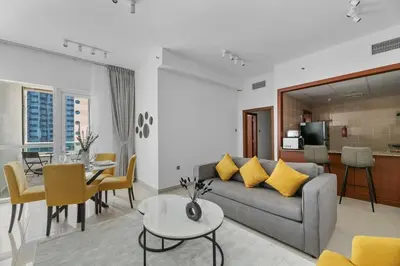 a living room with a couch and a table at StoneTree - Homelike 1BR in Dubai Marina in Dubai