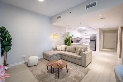 a living room with a couch and a table at Daniels Spacious 1BR in Heart of Dubai Marina in Dubai