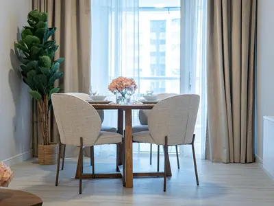 a dining room with a table and chairs and a window at Daniels Spacious 1BR in Heart of Dubai Marina in Dubai