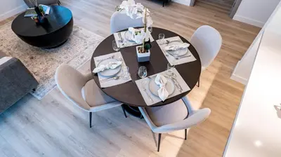 an overhead view of a dining room table and chairs at Classy 1 BR Apartment in Greens in Dubai