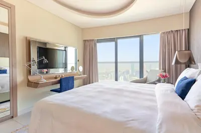 a hotel room with a large bed and a large window at ALiving Supreme 3BR I Paramount Towers, Business Bay- 6104 in Dubai
