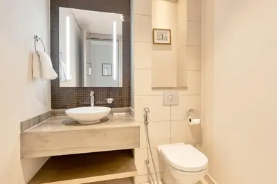 a bathroom with a sink and a toilet at ALiving Supreme 3BR I Paramount Towers, Business Bay- 6104 in Dubai