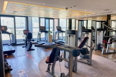 a gym with treadmills and exercise equipment in a building at ALiving Supreme 3BR I Paramount Towers, Business Bay- 6104 in Dubai
