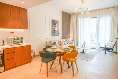a kitchen and living room with a table and chairs at Yogi - Luxury Apartment With Sea View Close to the Beach in Dubai