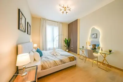 a bedroom with a bed and a desk and a window at Yogi - Luxury Apartment With Sea View Close to the Beach in Dubai