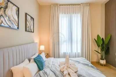 a bedroom with a bed with pillows and a window at Yogi - Luxury Apartment With Sea View Close to the Beach in Dubai