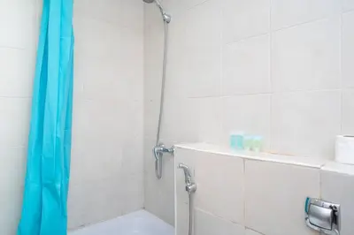 a shower with a blue shower curtain in a bathroom at StoneTree - Chic Studio in Jumeirah Lake Towers in Dubai
