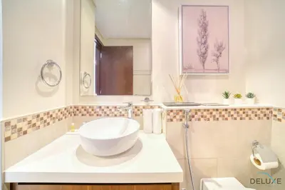 a bathroom with a bowl sink and a mirror at Contemporary 1BR at Vera Tower Business Bay by Deluxe Holiday Homes in Dubai