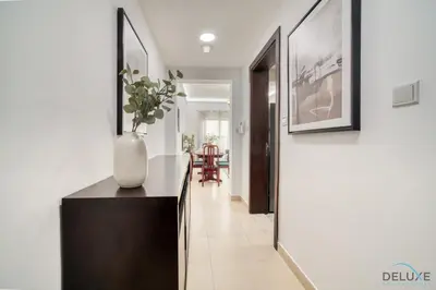 a hallway with a table and a vase on a counter at Ritzy 1BR at Global Golf Residence 2 Sports City by Deluxe Holiday Homes in Dubai