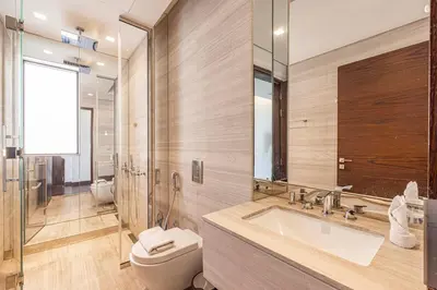 a bathroom with a sink and a toilet and a mirror at Daniels 5BR Villa with Private Pool at Damac Hills in Dubai