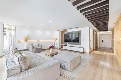 a living room with a couch and a tv at Daniels 5BR Villa with Private Pool at Damac Hills in Dubai