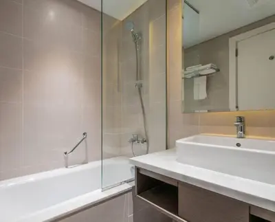 a bathroom with a tub and a sink and a shower at Phineek Homes Luxury Studio With Canal View Damac Maison Prive Business Bay in Dubai