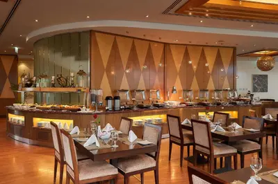 a restaurant with tables and chairs and a counter at City Premiere Marina Hotel Apartments in Dubai
