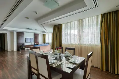 a dining room with a long table and chairs at City Premiere Marina Hotel Apartments in Dubai