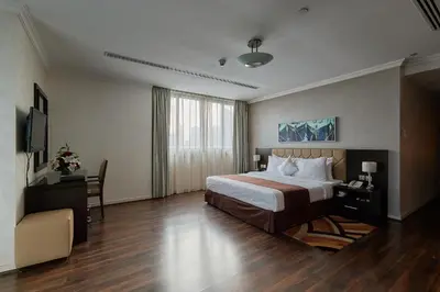 a hotel room with a bed and a desk and a television at City Premiere Marina Hotel Apartments in Dubai