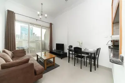 a living room with a couch and a table at StoneTree - Fully Furnished 1BR near Metro Station in Dubai