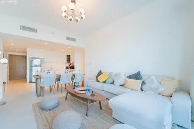 a living room with a couch and a table at Downtown Views II Tower 1 brand new units in Dubai
