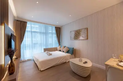 a bedroom with a bed and a couch and a table at Seven Palm, Palm Jumeirah - Mint Stay in Dubai