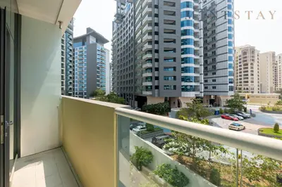 a balcony with a view of a city with tall buildings at Seven Palm, Palm Jumeirah - Mint Stay in Dubai