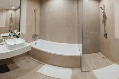 a bathroom with a shower and a tub and a sink at 2BR 1 Residences Zabeel with Sleeps 5 - Luxury Stay in Dubai
