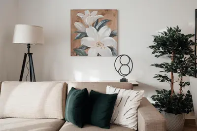 a living room with a couch with green and white pillows at 2BR 1 Residences Zabeel with Sleeps 5 - Luxury Stay in Dubai