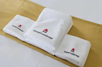 three white napkins sitting on a table at StoneTree - Unique 1BR Apartment in JLT in Dubai