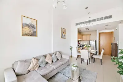 a living room with a couch and a table at StoneTree - Furnished 1BR with Canal View in Dubai