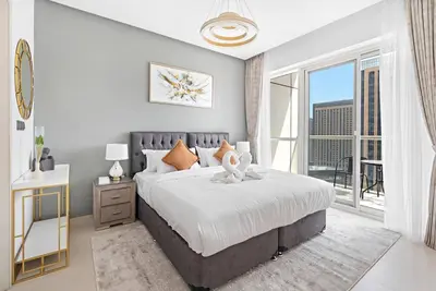 a bedroom with a large bed and a large window at StoneTree - Fabulous 1BR Apartment in Dubai Marina in Dubai