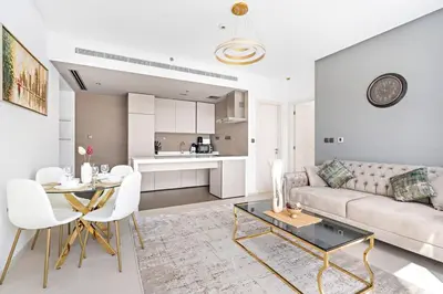 a living room with a couch and a table at StoneTree - Fabulous 1BR Apartment in Dubai Marina in Dubai