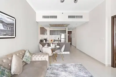 a living room with a couch and a dining room at StoneTree - Modern 1 BR Apartment in Dubai Marina in Dubai