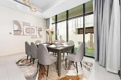 a dining room with a table and chairs at StoneTree - The Modern Family Friendly Villa in Dubai