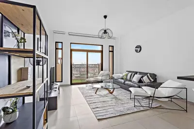 a living room with a couch and a table at StoneTree - Elegant 1 BR in Madinat Jumeirah Living Rahaal 2 in Dubai