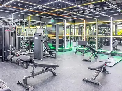a gym with several exercise equipment in a room at Comfy and stylish Studio in Regina Towers - JVC in Dubai