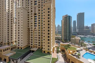 an aerial view of a city with tall buildings at Sleek Studio in JBR with Pool & Dubai Skyline View in Dubai