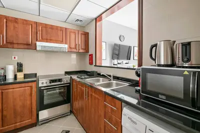 a kitchen with a sink and a stove top oven at StoneTree - NEW Furnished Studio in JLT in Dubai