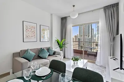 a living room with a couch and a table at StoneTree - NEW Modern 1BR in JLT in Dubai