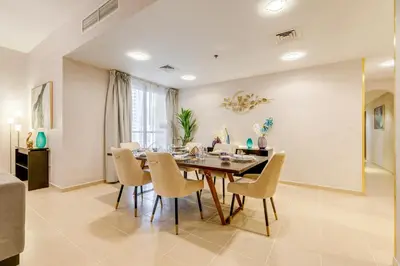 a dining room with a table and chairs at GlobalStay 3 Bedroom Apartment near JBR Beach Dubai Marina in Dubai
