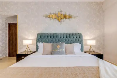 a bedroom with a large bed with a blue headboard at GlobalStay 3 Bedroom Apartment near JBR Beach Dubai Marina in Dubai