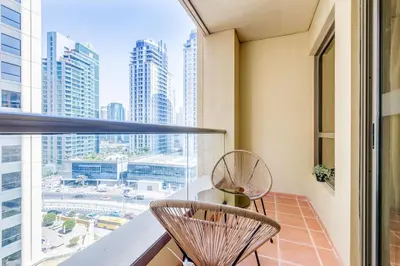 a balcony with two chairs and a view of the city at GlobalStay 3 Bedroom Apartment near JBR Beach Dubai Marina in Dubai